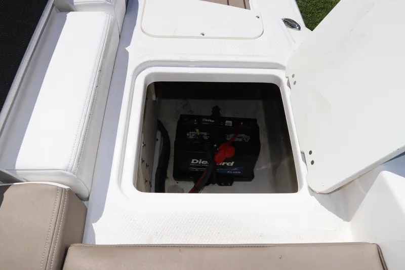 Slide: The Image of Battery compartment of 2021 Chaparral 23 SSi OB boat, featuring DieHard battery. - 11