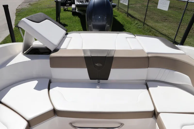 Slide: The Image of 2021 Chaparral 23 SSi OB boat interior with white and tan seating. - 13
