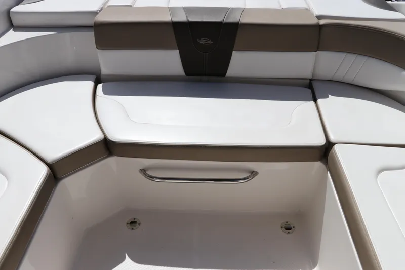 Slide: The Image of 2021 Chaparral 23 SSi OB boat seating area with white and brown cushions. - 16