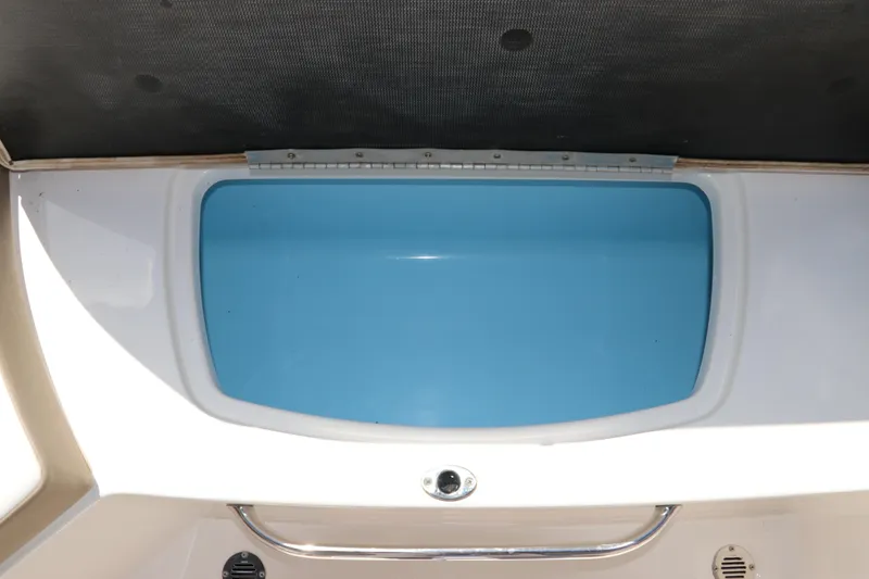 Slide: The Image of 2021 Chaparral 23 SSi OB boat storage compartment with blue interior. - 18