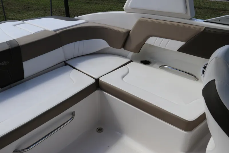 Slide: The Image of 2021 Chaparral 23 SSi OB boat interior with white and brown cushioned seating. - 20
