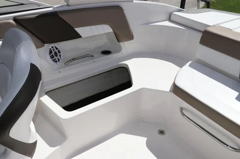 Slide: The Image of 2021 Chaparral 23 SSi OB boat interior with seating, speaker, and storage compartment. - 21