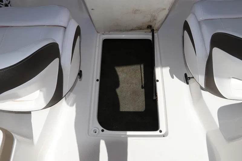 Slide: The Image of 2021 Chaparral 23 SSi OB boat interior with white and black seating. - 25