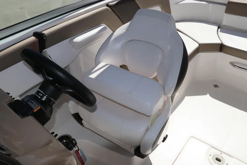 Slide: The Image of 2021 Chaparral 23 SSi OB boat interior with white captain's seat and steering wheel. - 28