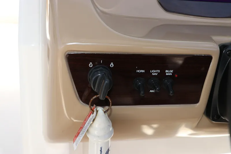Slide: The Image of Control panel of 2021 Chaparral 23 SSi OB boat with ignition and switches. - 32