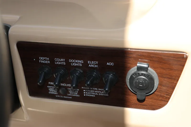 Slide: The Image of Control panel of 2021 Chaparral 23 SSi OB boat with switches and 12V outlet. - 33