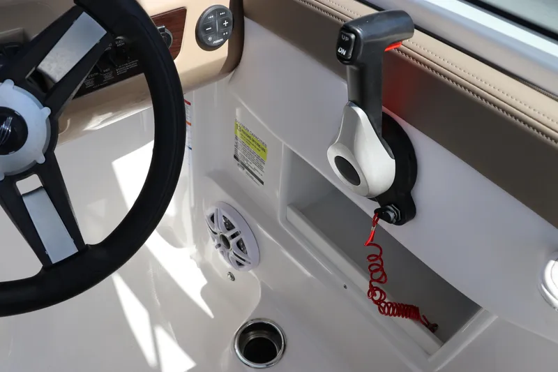 Slide: The Image of 2021 Chaparral 23 SSi OB boat cockpit with steering wheel and throttle control. - 35