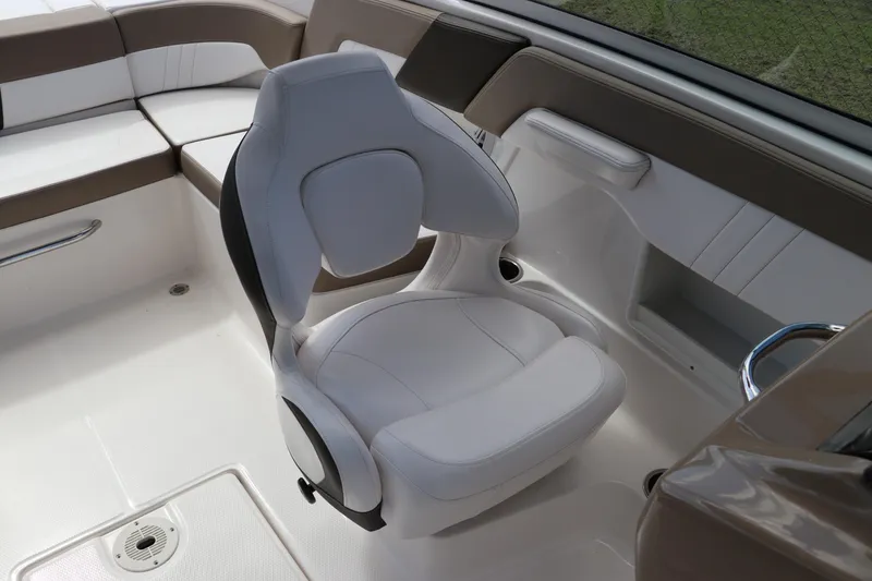 Slide: The Image of 2021 Chaparral 23 SSi OB boat interior with white and brown seating. - 37