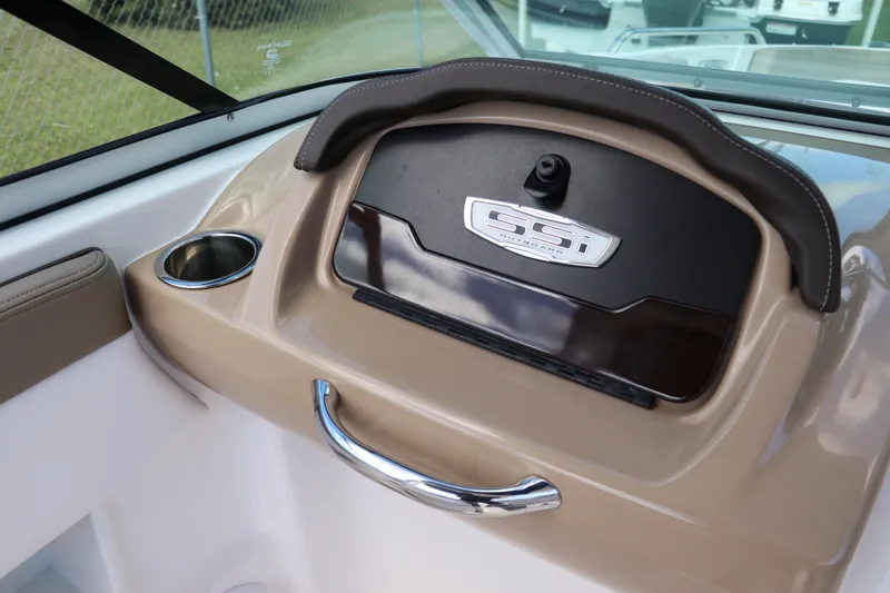 Slide: The Image of 2021 Chaparral 23 SSi OB boat dashboard with cup holder and storage compartment. - 40