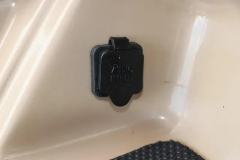 Slide: The Image of 2021 Chaparral 23 SSi OB boat detail, featuring a black plastic cover on a beige surface. - 42