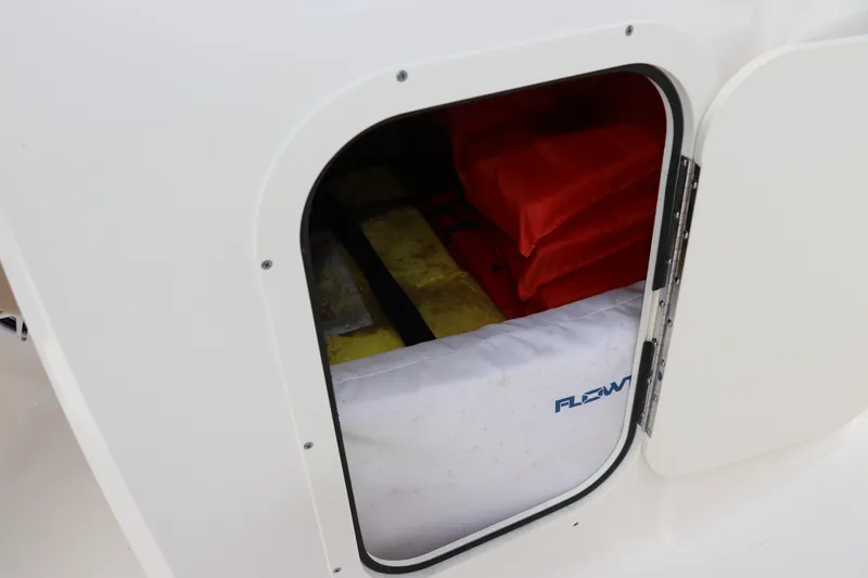 Slide: The Image of Storage compartment in 2021 Chaparral 23 SSi OB boat with life jackets and gear. - 46