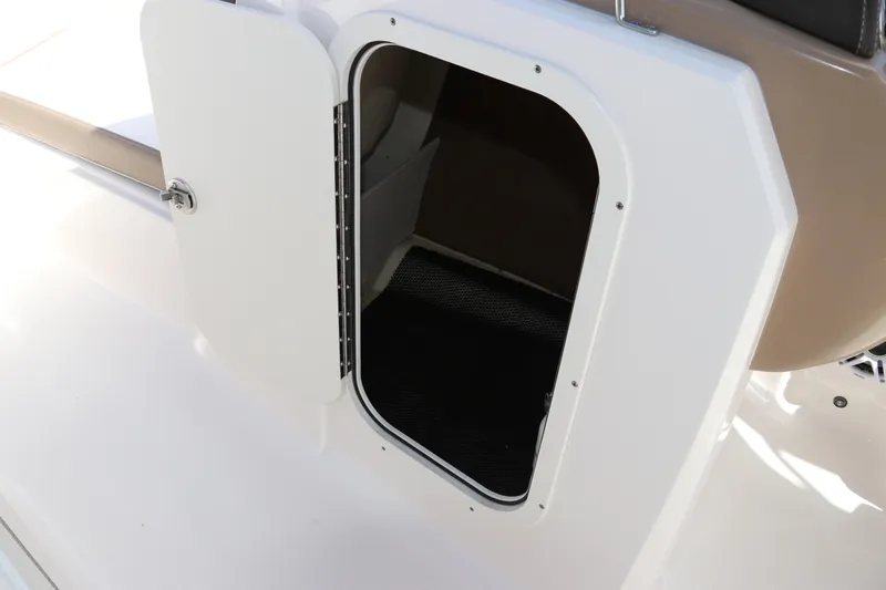 Slide: The Image of 2021 Chaparral 23 SSi OB boat storage compartment with open door. - 48