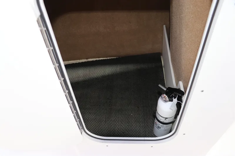 Slide: The Image of 2021 Chaparral 23 SSi OB storage compartment with fire extinguisher. - 49