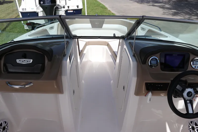 Slide: The Image of 2021 Chaparral 23 SSi OB boat interior with steering wheel and dashboard view. - 50