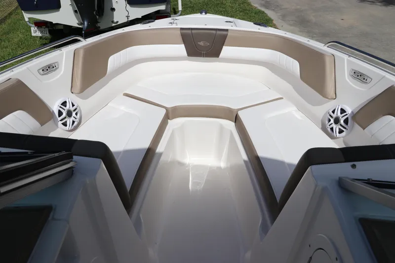 Slide: The Image of 2021 Chaparral 23 SSi OB boat interior with beige seating and speakers. - 51