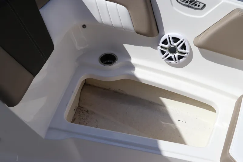 Slide: The Image of 2021 Chaparral 23 SSi OB boat interior with speaker and storage compartment. - 57