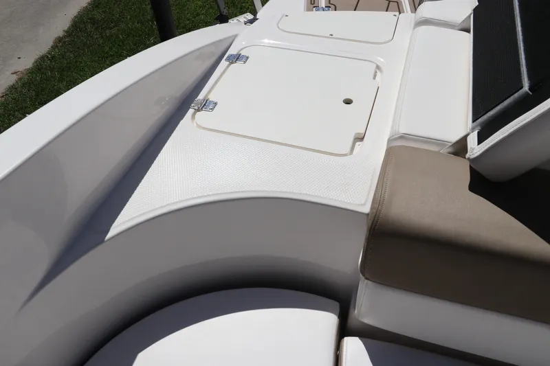 Slide: The Image of 2021 Chaparral 23 SSi OB boat interior with storage compartment and seating. - 8