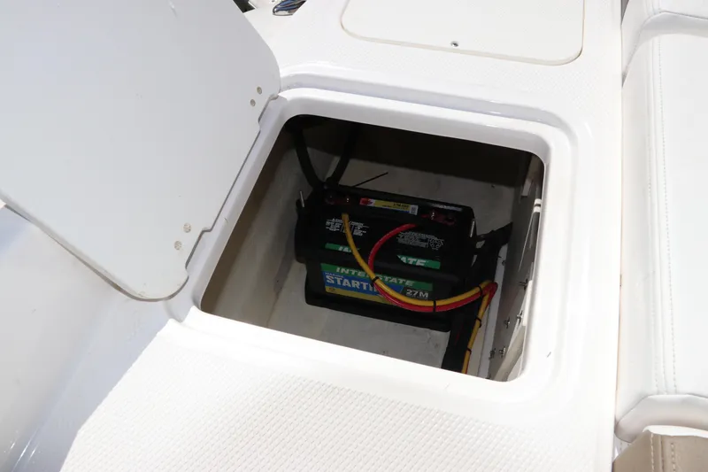 Slide: The Image of Battery compartment of 2021 Chaparral 23 SSi OB boat, featuring Interstate battery. - 9