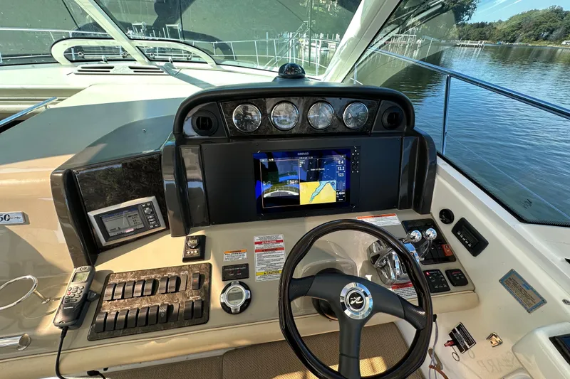 Slide: The Image of 2009 Sea Ray 48 Sundancer helm with navigation display and control panel. - 11