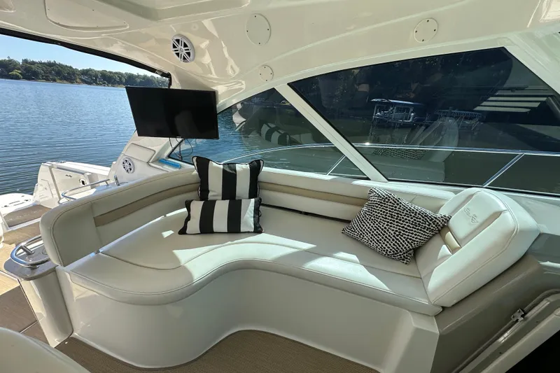 Slide: The Image of Luxurious 2009 Sea Ray 48 Sundancer yacht interior with plush seating and scenic water view. - 13