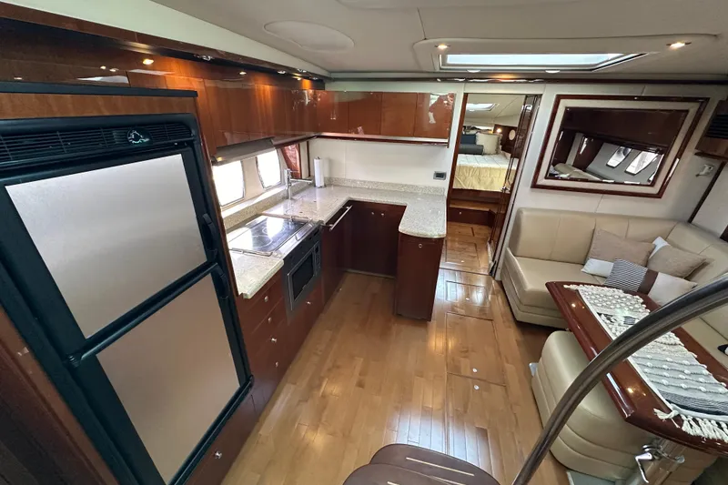 Slide: The Image of Luxurious interior of 2009 Sea Ray 48 Sundancer yacht with modern kitchen and seating area. - 14