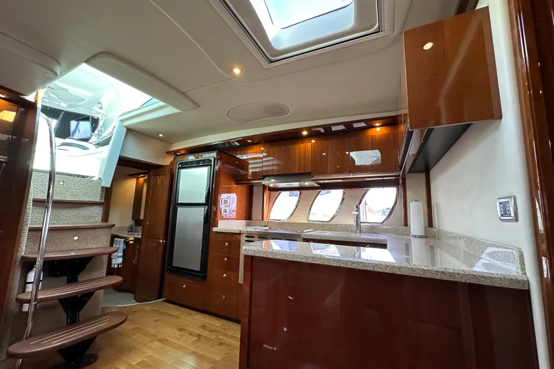 Slide: The Image of Luxurious interior of 2009 Sea Ray 48 Sundancer yacht with modern kitchen and staircase. - 18