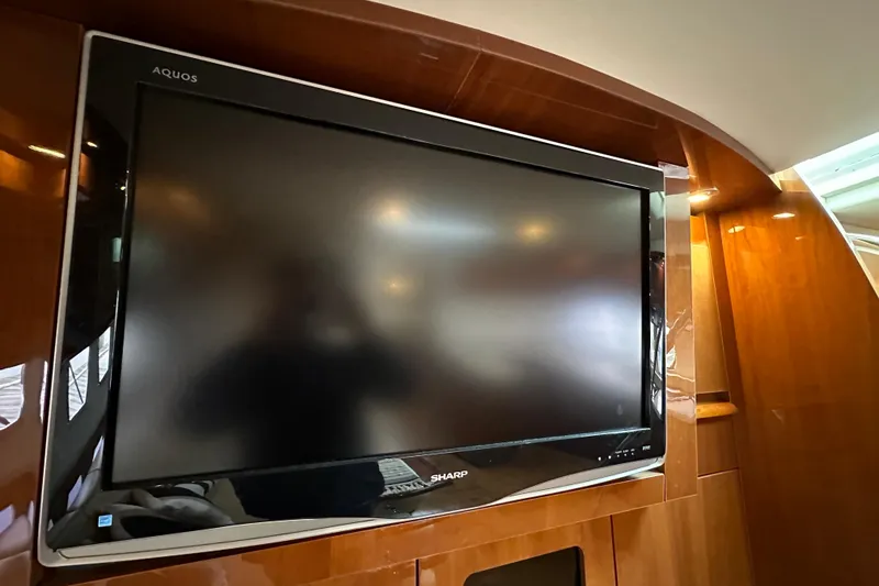 Slide: The Image of Flat-screen TV in 2009 Sea Ray 48 Sundancer yacht interior, wooden paneling. - 20
