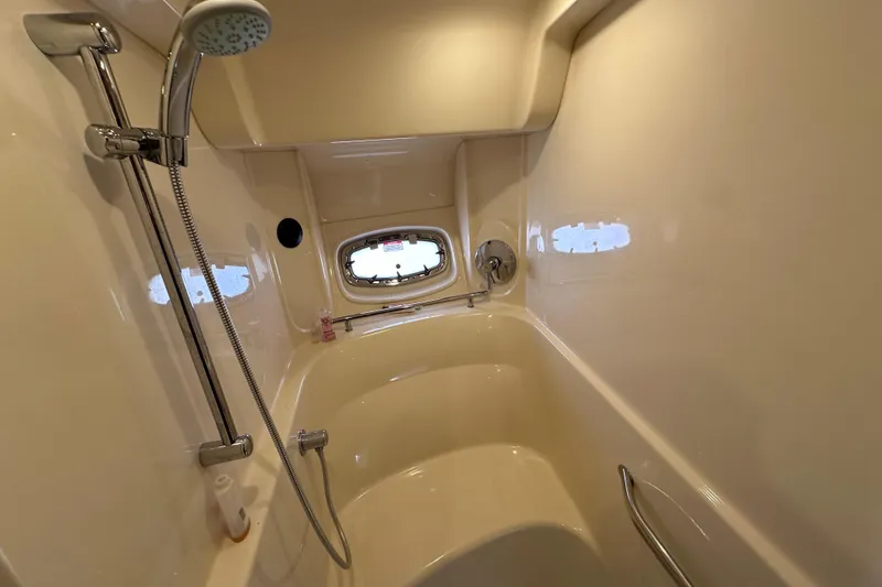 Slide: The Image of Luxurious bathroom in 2009 Sea Ray 48 Sundancer yacht with shower and porthole window. - 30