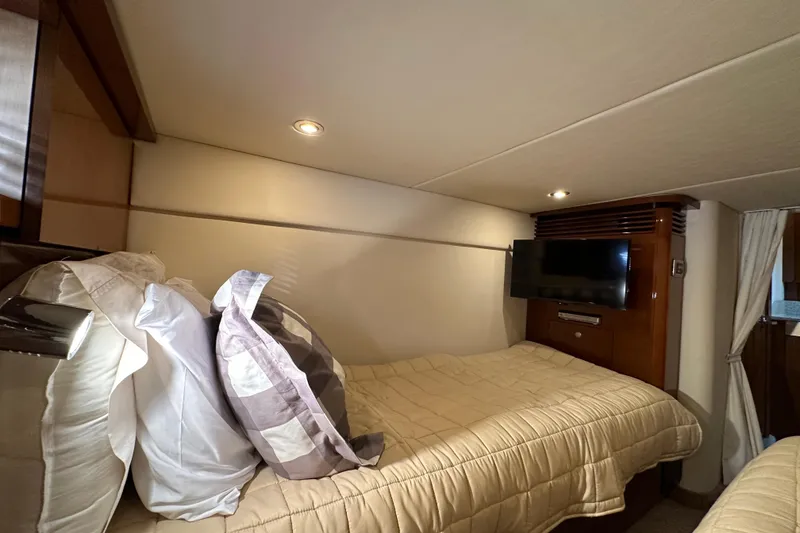 Slide: The Image of Luxurious cabin interior of 2009 Sea Ray 48 Sundancer yacht with cozy bedding and TV. - 33