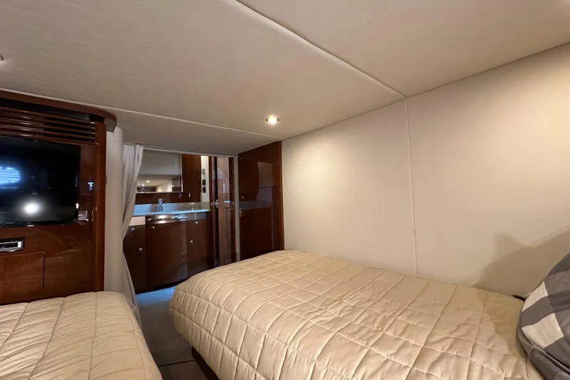 Slide: The Image of Interior cabin of 2009 Sea Ray 48 Sundancer yacht with twin beds and TV. - 34