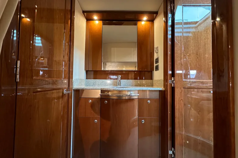Slide: The Image of Luxurious 2009 Sea Ray 48 Sundancer yacht interior with polished wood cabinetry and modern fixtures. - 35