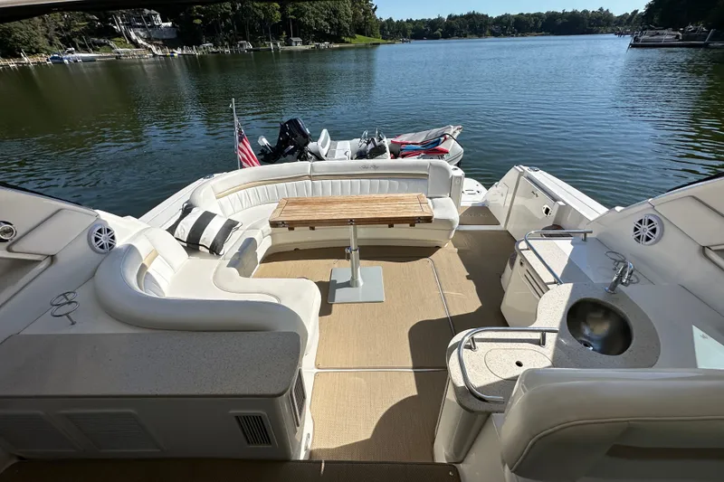 Slide: The Image of Luxurious 2009 Sea Ray 48 Sundancer yacht interior with seating, table, and lake view. - 5