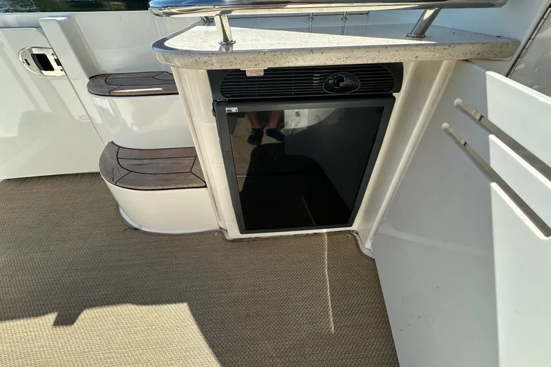 Slide: The Image of 2009 Sea Ray 48 Sundancer boat interior with steps and mini fridge. - 8