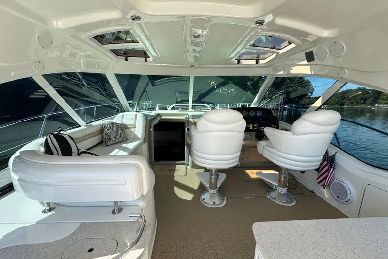 Slide: The Image of Luxurious 2009 Sea Ray 48 Sundancer yacht interior with plush seating and panoramic windows. - 9