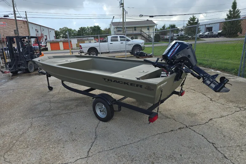 Slide: The Image of 2024 Tracker Grizzly 1648 Jon boat with Mercury outboard motor on trailer. - 2