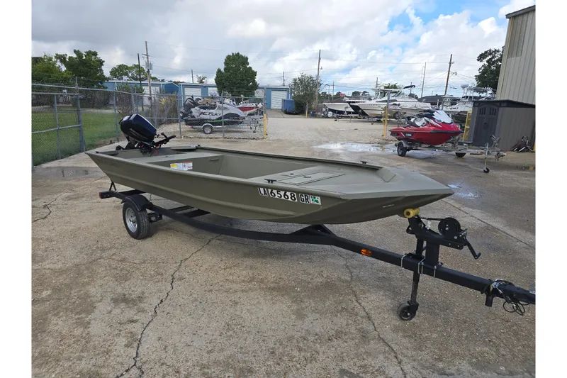 Slide: The Image of 2024 Tracker Grizzly 1648 Jon boat on trailer in outdoor lot. - 5