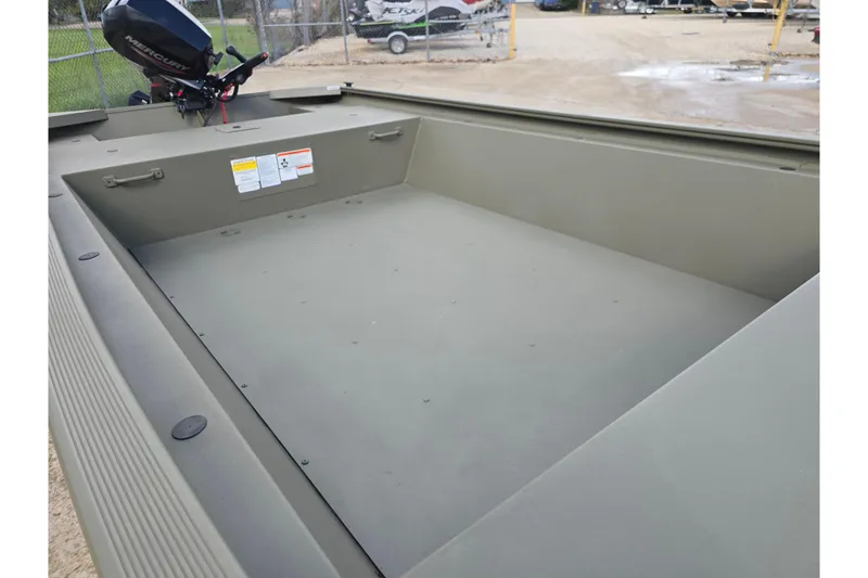 Slide: The Image of 2024 Tracker Grizzly 1648 Jon boat interior with Mercury outboard motor. - 6