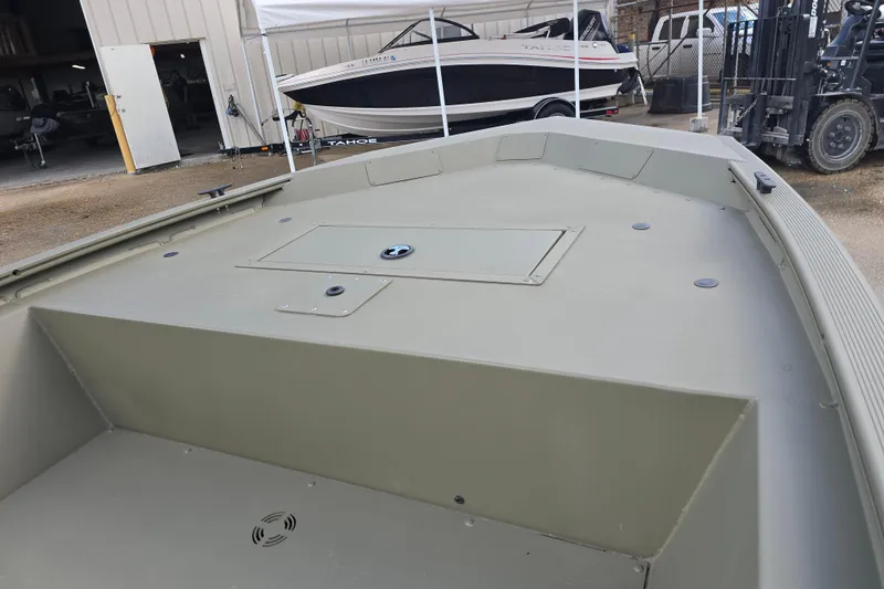 Slide: The Image of 2024 Tracker Grizzly 1648 Jon boat interior, showcasing spacious deck and storage compartment. - 7