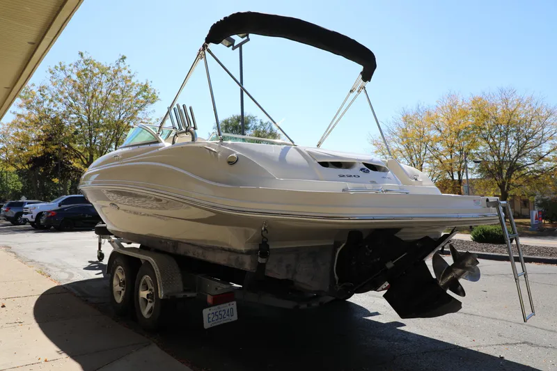 Slide: The Image of 2008 Sea Ray 220 Sundeck boat on trailer, parked outdoors, sunny day. - 12