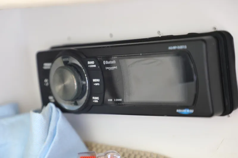 Slide: The Image of Close-up of a 2008 Sea Ray 220 Sundeck stereo system with Bluetooth functionality. - 13