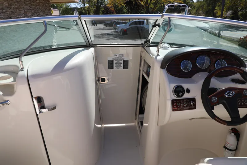 Slide: The Image of 2008 Sea Ray 220 Sundeck boat interior with steering wheel and dashboard controls. - 16