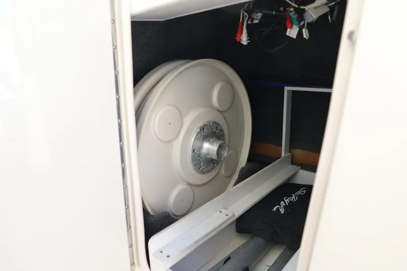 Slide: The Image of Storage compartment of a 2008 Sea Ray 220 Sundeck boat with spare wheel and wiring. - 17
