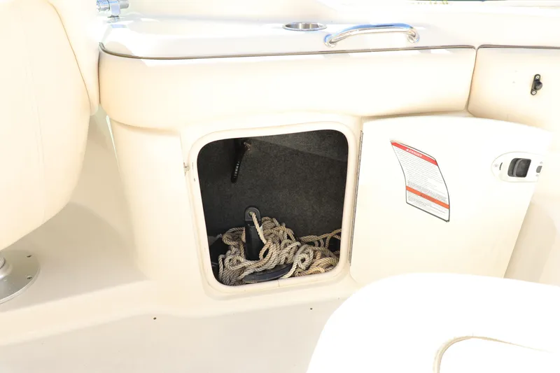 Slide: The Image of Open storage compartment on 2008 Sea Ray 220 Sundeck with rope inside. - 21