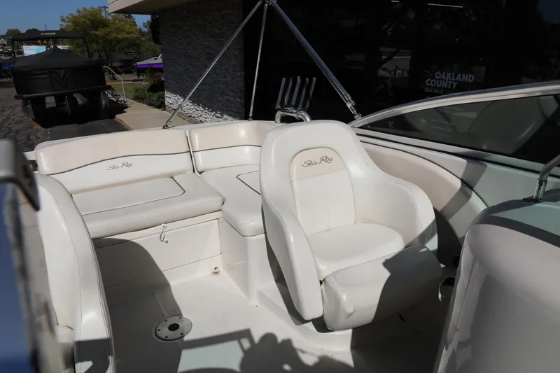 Slide: The Image of 2008 Sea Ray 220 Sundeck interior with white seating and helm. - 22