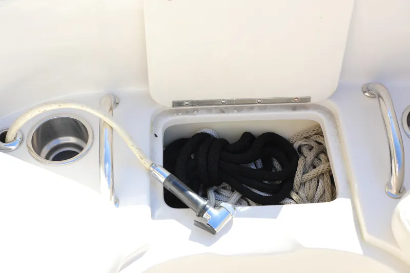 Slide: The Image of Storage compartment on 2008 Sea Ray 220 Sundeck with ropes and a hose. - 26