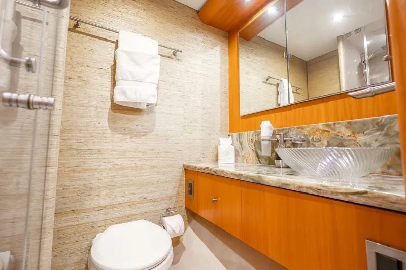 Slide: The Image of Luxurious bathroom on 2008 Lazzara Motor Yacht with elegant glass sink and marble countertop. - 44