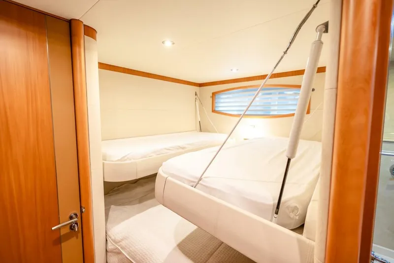 Slide: The Image of Luxurious 2008 Lazzara Motor Yacht cabin with twin beds and elegant wood accents. - 49