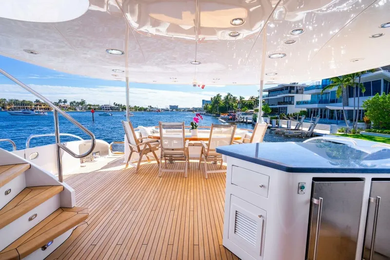 Slide: The Image of Luxurious 2008 Lazzara motor yacht deck with dining area, overlooking serene waterfront views. - 52