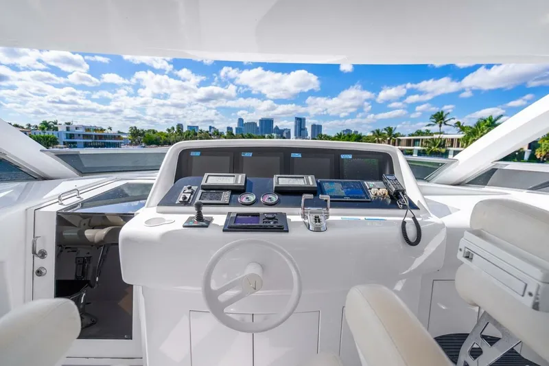 Slide: The Image of 2008 Lazzara Motor Yacht helm with modern controls, overlooking a scenic waterfront and city skyline. - 72