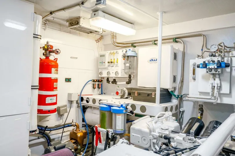 Slide: The Image of Engine room of a 2008 Lazzara Motor Yacht with equipment and fire extinguisher. - 74